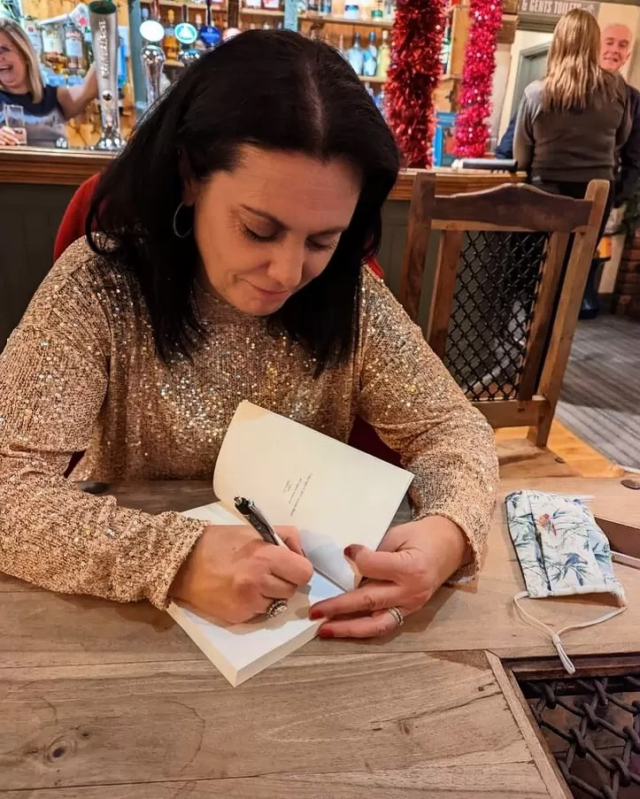 Me signing my book in the pub